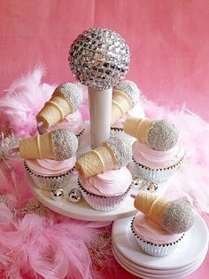 cupcakes and ice cream cones are arranged in a cone with pink icing