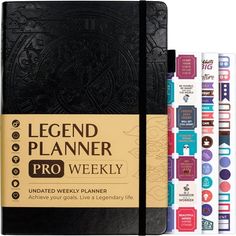 the legend planner pro weekly planner is next to four books