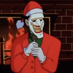 an animated image of a man dressed as the joker in front of a fire place