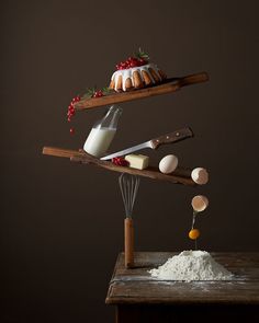 an assortment of desserts on wooden serving trays with utensils and ingredients