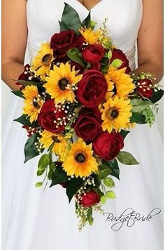 a bride holding a bouquet of sunflowers and red roses in her wedding dress