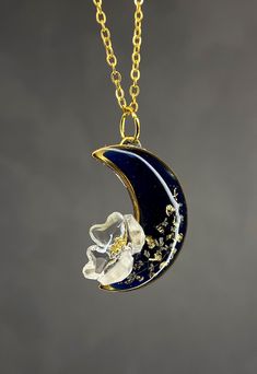 Moon with natural flower form epoxied risen This pendant was handcrafted in resin. Color risen: deep blue near to black Available 2 color: cold and silver The components are in steel (nickel free) Terri Black Pressed Flowers Jewelry Gift, Blue Moon Shaped Necklace For Gift, Blue Moon Necklace For Gift, Handmade Celestial Resin Jewelry, Blue Crescent Necklace For Gifts, Blue Crescent Necklace For Gift, Black Moon Shaped Jewelry Gift, Black Moon-shaped Jewelry For Gift, Black Moon Shaped Jewelry For Gift