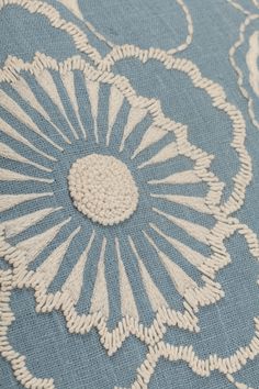 a blue and white rug with an intricate flower design on the bottom half of it