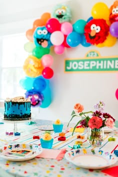 there is a birthday cake and cupcakes on the table