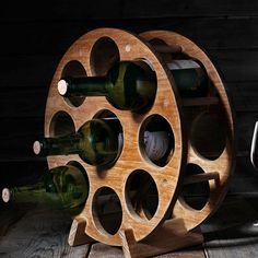 a wooden wine rack holding several bottles and glasses