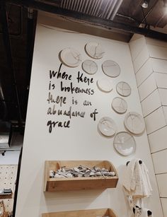 there is a display in the store that has some items on it and words written on the wall