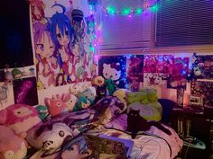 a room with many stuffed animals on the bed and lights in the window behind it