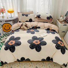 a bed with black and white flowers on it