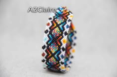 a beaded bracelet with multicolored beads on it and the words azclaire