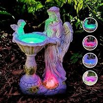 an angel fountain with four different colored lights