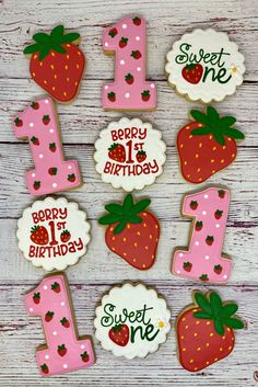 decorated cookies with the number one and strawberrys on them for 1st birthday party favors