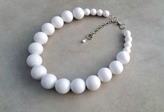 Simple retro white necklace made of high quality solid acrylic beads. The necklace is finished with silver stainless steel extender chain and stainless steel NON TARNISH metal parts. Gorgeous choice for your summer holidays,bridesmaid gift or as an everyday necklace. Measurements: 16,5 inches plus 2'' extender chain. *Available in: https://www.etsy.com/listing/1179677206/chunky-statement-red-necklace-bright-red https://www.etsy.com/listing/1207148950/chunky-yellow-statement-retro-necklace https: Everyday Necklace Simple, Retro Necklace, Jewelry White, Red Necklace, Chunky Beads, Necklace Simple, Everyday Necklace, Necklace White, White Necklace