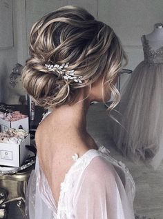 the back of a woman's head wearing a bridal gown and hair comb