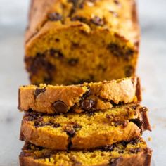 a loaf of chocolate chip banana bread on a counter with one slice cut off and the other half eaten