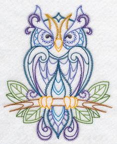 an embroidered owl sitting on top of a tree branch