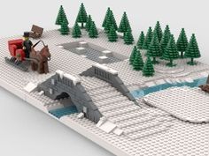 a lego model of a man and woman riding horses on a bridge over a river