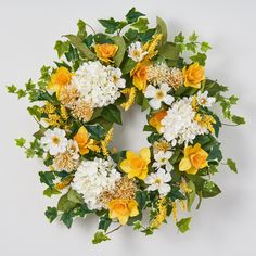 a wreath with yellow and white flowers on it