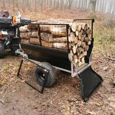 a trailer loaded with logs in the woods