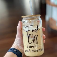 a person holding up a drink with a straw in it's mouth and the words, truck off i mean good morning