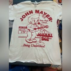 Brand New John Mayer 2019 Tour Tee! Size Medium. Pit To Pit 19” Such An Awesome Tee! White Band Logo Graphic Tee, Pop Culture Cotton Top With Band Logo, White Cotton Band Logo Top, White Cotton Shirt With Band Logo, White Casual Top With Band Logo, Casual White Top With Band Logo, White Cotton Top With Band Logo, John Mayer, Cool Tees