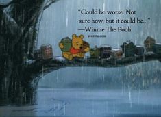 winnie the pooh sitting on a tree in the rain with his trunk hanging down