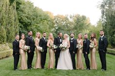 a group of people in formal wear posing for a photo