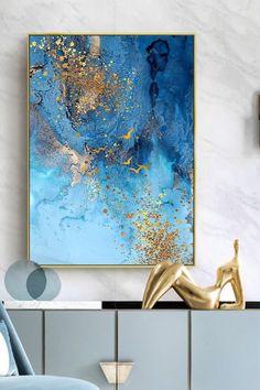 a blue and gold abstract painting in a living room