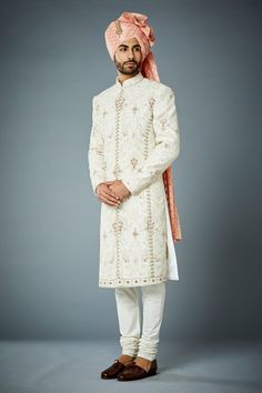 Ivory sherwani with thread, bead embroidery in floral pattern. Paired with kurta and churidar.
Components: 3
Pattern: Embroidery
Type Of Work: Thread, bead, floral
Neckline: Mandarin collar
Sleeve Type: Full sleeves
Fabric: Sherwani: Poly Viscose, Kurta and Churidar: Cotton Silk
Color: Ivory
Other Details: 
Front concealed button placket
Note: Turban and kalangi worn by the model is not for sale
Occasion: Destination Wedding - Aza Fashions White Churidar With Intricate Embroidery For Formal Occasions, White Semi-stitched Sherwani For Reception, Formal White Churidar With Intricate Embroidery, Off White Sherwani With Dabka Work For Wedding, Off White Dabka Work Sherwani For Wedding, Off White Sherwani With Chikankari Embroidery For Reception, White Long Bandhgala With Intricate Embroidery, White Churidar With Intricate Embroidery For Ceremonial Occasions, Elegant Off White Sherwani With Dabka Work