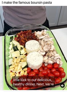 a glass dish filled with lots of different types of food on top of a table