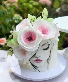 a white cake with pink flowers on top