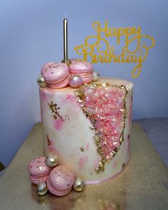 a birthday cake with pink and gold decorations