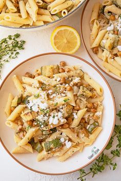 two plates filled with pasta and garnished with parmesan cheese