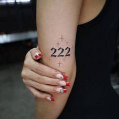 a woman's arm with the number 22 on it and stars around her wrist