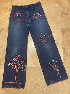 "Vintage 70s Denim Jeans - Awesome Embroidered Designs - Sun, Tree, Snake LOVE ROCKS VINTAGE ITEM DETAILS & DESCRIPTION . Amazing Embroidered Designs - Sun, Snake, Tree . Zip & Button Fly . Belt Loops Label: N/a - appear handmade Size: no size - Refer to measurements - Vintage size tends to run smaller. NO RETURNS FOR NOT FITTING! Era: est. 1970s Color: Blue Denim - refer to Photographs Material: Cotton Denim Condition: - True Vintage - Very Good - previously owned - expect vintage wear 70s Inspired Denim Jeans For Spring, Spring Hippie Medium Wash Jeans, 70s Inspired Spring Denim Jeans, Vintage Embroidered Denim Blue Bottoms, Fitted Cotton Jeans With Multicolor Embroidery, Hippie Style Blue Jeans For Festivals, Retro Embroidered Denim Bottoms, Retro Embroidered Bottoms For Spring, Retro Cotton Jeans For Festivals