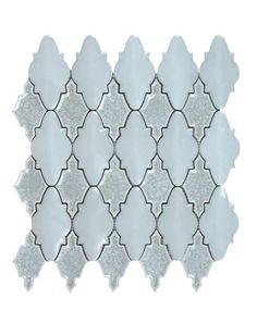 white and silver mosaic tile with an intricate design on the back side, against a white background