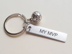 a metal keychain with a soccer ball on it that says, my mmp