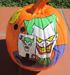 a pumpkin decorated with an image of the joker