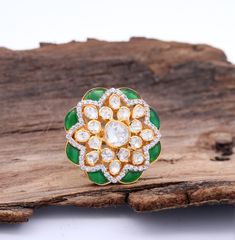 Experience elegance and grace with our premium Flower-shaped Ring adorned with Green and White Kemp stones. This exquisite piece of jewelry is finely crafted in 925 Silver, presenting an authentic Indian style ring with high carat gold-plated silver. Meticulously handcrafted by our skilled artisans in India, this traditional ring features an adjustable band, offering ease and convenience as it gracefully adjusts to any finger. Gross Weight: 9.8 gms Dimensions: 30mm Ring size: Adjustable Explore more in our shop: [TempusGems](https://www.etsy.com/in-en/shop/TempusGems) Packaging and Shipping We take great care to ensure your item reaches you in pristine condition: 1. Secure packaging in a zip pouch 2. Additional protection using a Bubble Pouch Orders are typically processed within 3-5 busin Victorian Rings Vintage, Jewelry Indian Wedding, Traditional Wedding Jewellery, Traditional Ring, Gold Finger Rings, Traditional Indian Jewellery, Pakistani Jewelry, Open Bangle, Authentic Indian