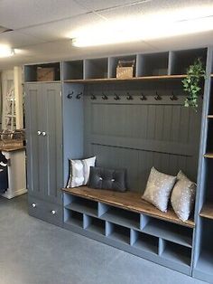 a room filled with lots of gray shelves and pillows on top of it's sides