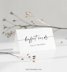 a white business card with the words best cards on it next to some dried branches