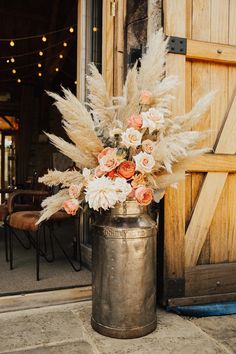 Boho wedding at Tythe Barn with pampas grass and orange and white wedding roses Boho Western Flower Arrangements, Boho Rustic Wedding Decor Ideas, Peach And Pampas Wedding, Fall Pampas Grass Wedding, Rustic Boho Bouquet Wedding, Western Pampas Grass Decor, Rustic Pampas Wedding Decor, Pampas Grass In Milk Can, Pink And Pampas Wedding