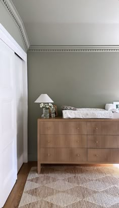 a bed sitting on top of a wooden dresser