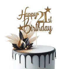 a happy 21st birthday cake topper with gold glitter and black icing on a white frosted cake