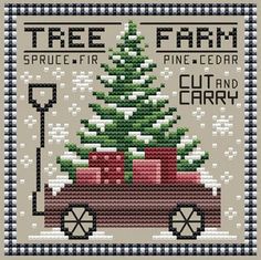 a cross stitch christmas tree on top of a car with a shovel in the back