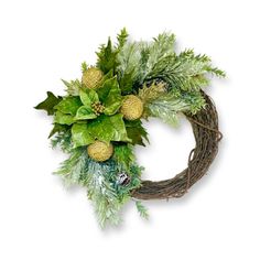 a wreath with green leaves and pine cones