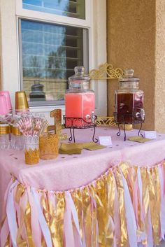 a table topped with pink and gold desserts