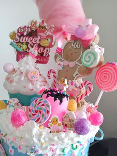 there is a cake decorated with candy, candies and other decorations on top of it