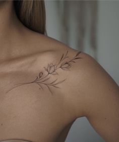 a woman with a flower tattoo on her chest