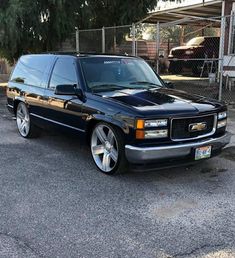 a black station wagon parked in a parking lot