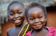 two young children are smiling for the camera